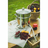 Estrattore succo in acciaio inox Baumalu con frutti freschi sulla tavola di legno