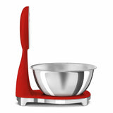 Bilancia da cucina Smeg rossa con design elegante e ciotola in acciaio inox per pesare ingredienti